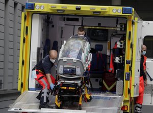 An empty stretcher is carried back into an ambulance which is believed to have transported Alexei Navalny at the emergency entrance of the Charite hospital in Berlin, Germany