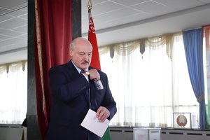 Belarusian President Alexander Lukashenko  walks to cast his ballot at a polling station during the presidential election in Minsk, Belarus, Sunday, Aug. 9, 2020.