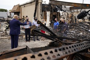 President Donald Trump talks to business owners Tuesday, Sept. 1, 2020, as he tours an area damaged during demonstrations after a police officer shot Jacob Blake in Kenosha, Wisconsin