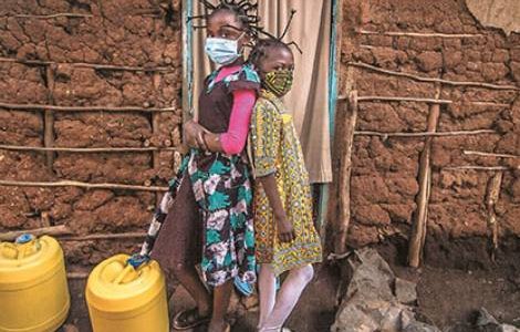 In Kibera, Nairobi, Martha Apisa and Stacy Ayuma use their braids to raise awareness of the virus by imitating its shape. Community health efforts are intense as social distancing is impossible and sanitation is poor in Kenya’s largest slum.  Donwilson Odhiambo/Sopa/Zuma/Alamy 