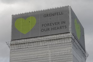 Close up of Grenfell Tower with banners in June 2018