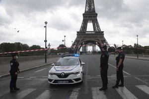 French police officers secure the bridge leading to the Eiffel Tower, Wednesday, Sept. 23, 2020 in Paris.