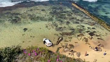 Car crashes on Bar Beach in Newcastle after driving off a cliff. 