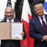 Israeli Prime Minister Benjamin Netanyahu and US President Donald Trump hold the signed documents at the White House.