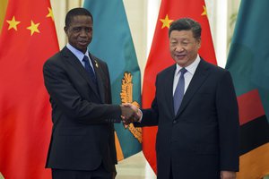 Zambia's President Edgar Lungu (L) shake hands with China's President Xi Jinping (R) before their bilateral meeting at the Great Hall of the People on September 1, 2018