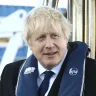 Britain's Home Secretary Priti Patel with Prime Minister Boris Johnson aboard a security boat in the Port of Southampton during election campaigning in 2019.