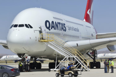 A Qantas Airbus A380 arrives at Southern California Logistics Airport in Victorville, Calif., Monday, July 6, 2020. Australia's largest airline said last month it plans to cut at least 6,000 jobs and keep 15,000 more workers on extended furloughs as it tries to survive the coronavirus pandemic. (AP Photo/Matt Hartman)