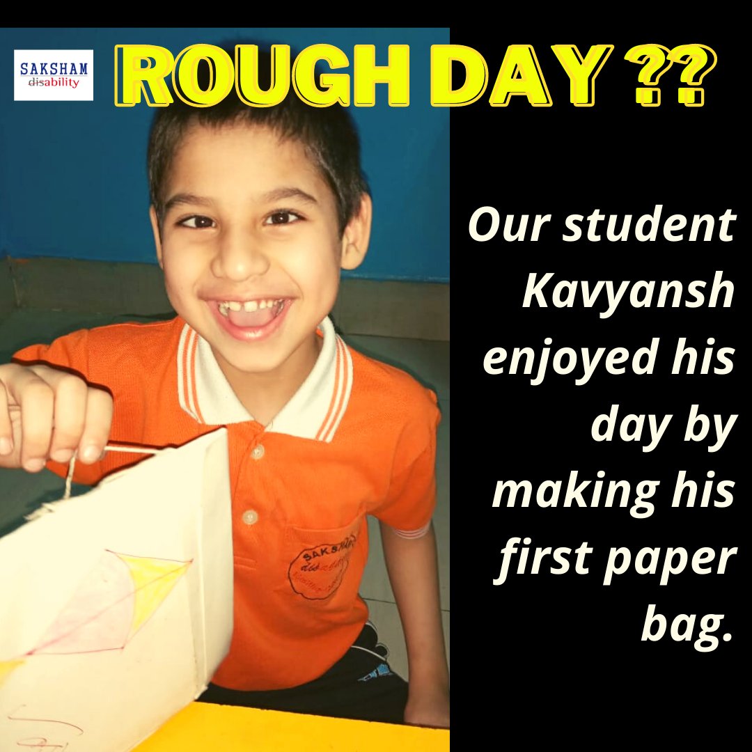 A kid with a happy face holding a paper bag made by him.