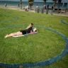 A Melburnian enjoys time outdoors from a socially distant circle in at St Kilda beach.