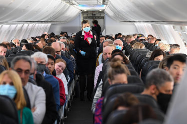 assengers and crew onboard a Qantas Boeing 737-800, flight number QF735 from Sydney to Adelaide at Sydney Airport on September 24, 2020 in Sydney, Australia. Flights from Sydney to Adelaide have resumed after the South Australian government's decision to lift COVID-19 travel restrictions for NSW residents. From Thursday 24 September, travellers from New South Wales are able to enter South Australia without having to go into a mandatory 14-day quarantine. (Photo by James D. Morgan/Getty Images) Getty image for Traveller. Single use only. Flight from Sydney to Adelaide after South Australia border reopens to NSW residents.