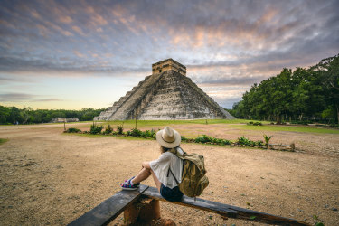 <p>One woman admiring Kukulkan pyramid at Chichen-Itza archaeological site, Yucatan, Mexico</p>
