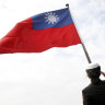 A Taiwanese military officer salutes the Taiwanese flag.