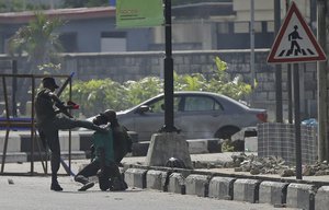 Police officers detain a protester at the Lekki toll gate in Lagos, Nigeria