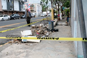 File - A man looks up at a damaged building in the aftermath of Hurricane Irma & Maria in San Juan, Puerto Rico, November, 2017.