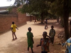 Children playing soccer with self-made plastic balls. They recycled the water plastics and made balloons for them, Cameroon