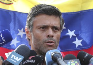 Venezuelan opposition leader Leopoldo Lopez speaks during a press conference at the gate of the Spanish ambassador's residence in Caracas, Venezuela