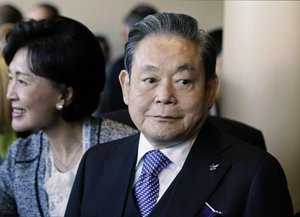 Samsung Chairman Lee Kun-hee, right, greets people from the South Korean delegation in Durban, South Africa