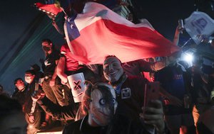 People gather at Plaza Italia on the day Chileans voted in a referendum to decide whether the country should replace its 40-year-old constitution, written during the dictatorship of Gen. Augusto Pinochet, in Santiago, Chile, Sunday, Oct. 25, 2020.