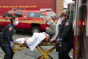 File - Staff of Elmhurst Hospital in Queens, arrives with a new Coronavirus patient during the COVID-19 outbreak in New York, 3 April 2020.