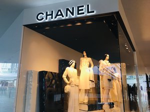 Mannequins on display at a Chanel window inside a mall in Singapore.