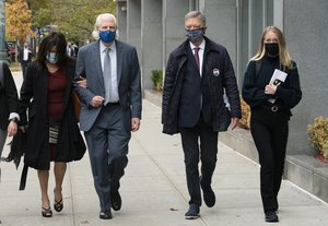 Toni Natalie, left, and India Oxenberg, right, arrive with their attorneys at Brooklyn federal court for a sentencing hearing for self-improvement guru Keith Raniere, Tuesday, Oct. 27, 2020 in New York