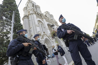 Police officers stand guard near Notre-Dame Cathedral in Nice.