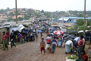 File - People shop for vegetables at the Kutupalong Rohingya refugee camp in Cox's Bazar, Bangladesh, Tuesday, June 2, 2020. Authorities in Bangladesh have confirmed the first death of a Rohingya refugee from the coronavirus, as infections rise in sprawling camps where more than 1 million Rohingya Muslims have been living since fleeing from neighboring Myanmar.