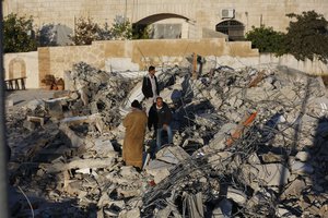 File - Palestinians inspect a house after it was demolished by the Israeli army in the West Bank city of Jenin, Thursday, Feb. 6, 2020.