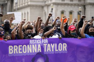 File - Black Lives Matter protesters march, Friday, Sept. 25, 2020, in Louisville. Breonna Taylor's family demanded Friday that Kentucky authorities release all body camera footage, police files and the transcripts of the grand jury hearings that led to no charges against police officers who killed the Black woman during a March drug raid at her apartment.