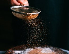 sifting cinnamon sugar