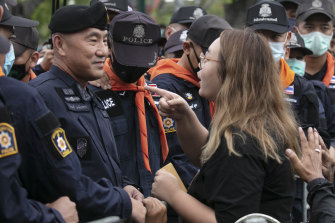 Protest leader Panusaya Sithijirawattanakul, confronting police on September 20, has been charged with sedition.