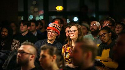 A man and a woman in the audience of a film viewing