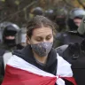 Police detain a protester during an opposition rally to protest the official presidential election results in Minsk, Belarus.