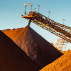 Iron ore falls from a conveyor to a stockpile at the port in Port  Hedland.