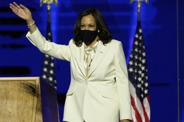 Vice President-elect Kamala Harris waves as she takes the stage before speaking.