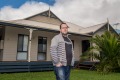 Joel Rudd, director of Phillip Island Holiday Homes, stands outside one of his holiday rentals.