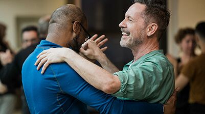 Two men dancing a tango at a dance class