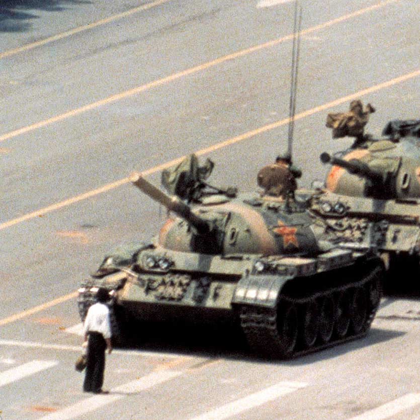 A anonymous man stands in front of a column of tanks on June 5, 1989, the morning after the Chinese military had suppressed the Tiananmen Square protests of 1989 by force, who later became known as the Tank Man. The tanks manoeuvred to pass by the man, and he moved to continue to obstruct them, in something like a dance.