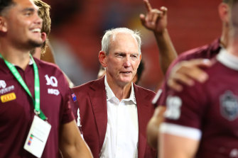 A contented Wayne Bennett looks on as the Maroons celebrate a famous victory.