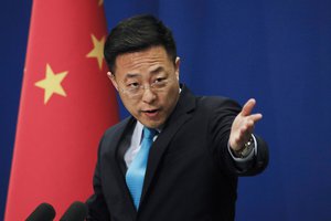 Chinese Foreign Ministry new spokesman Zhao Lijian gestures as he speaks during a daily briefing at the Ministry of Foreign Affairs office in Beijing, Monday, Feb. 24, 2020