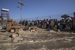 People who fled the conflict in Ethiopia's Tigray region wait for UNHCR to distribute blankets at Hamdayet Transition Center, eastern Sudan, Saturday, Nov. 21, 2020.