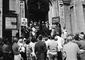 The Rev. Robert L.T. Smith, near top right, a Jackson, Miss., clergyman, addresses the crowd from the steps of the Washington Methodist Church in New York, June 23, 1963. The address by the visiting clergyman brought to a conclusion a six-car "Motorcade of Mourning" for slain civil rights leader Medgar Evers, who was murdered in Jackson on June 12.