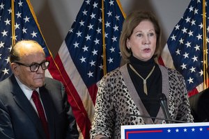 Sidney Powell, right, speaks next to former Mayor of New York Rudy Giuliani, as members of President Donald Trump's legal team, during a news conference at the Republican National Committee headquarters, Thursday Nov. 19, 2020, in Washington.