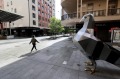 A women walks past the giant pigeon statue in an empty Rundle Mall as lockdown restrictions were imposed in Adelaide.