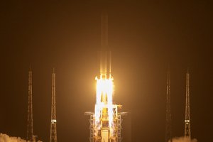 A Long March-5 rocket carrying the Chang'e 5 lunar mission lifts off at the Wenchang Space Launch Center in Wenchang in southern China's Hainan Province, early Tuesday, Nov. 24, 2020.