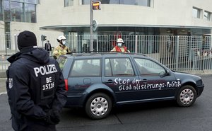 A car stand in front of the chancellery after it crashed into the front gate of the building housing German Chancellors Angela Merkel's offices in Berlin, Germany, Wednesday, Nov. 25, 2020