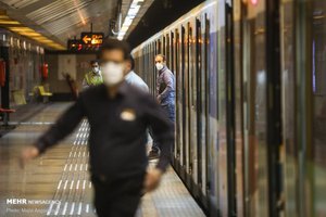 People wear protective mask to help prevent coronavirus in a metro station, in Tehran, Iran