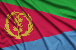 Eritrea flag  is depicted on a sports cloth fabric with many folds. Sport team waving banner�