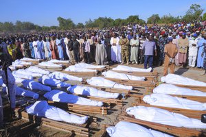 People attend a funeral for those killed by suspected Boko Haram militants in Zaabarmar, Nigeria, Sunday, Nov. 29, 2020.