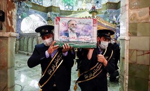 military personnel carry the flag draped coffin of Mohsen Fakhrizadeh